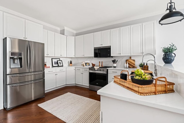 kitchen featuring stainless steel appliances, white cabinets, light countertops, ornamental molding, and dark wood-style floors