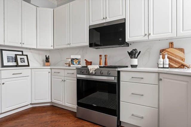 kitchen featuring dark wood-style floors, light countertops, white cabinets, and stainless steel gas stove