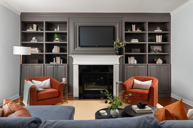 living room with ornamental molding, wood finished floors, a tile fireplace, and baseboards