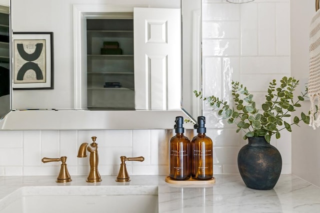 details featuring backsplash and a sink