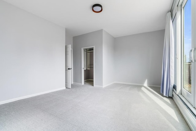 unfurnished bedroom featuring baseboards and light colored carpet