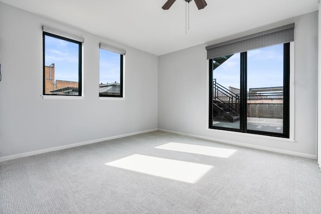 unfurnished room with carpet floors, ceiling fan, and baseboards