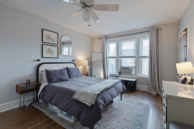 bedroom with cooling unit, ceiling fan, baseboards, and wood finished floors