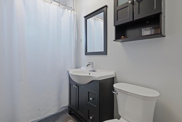 full bathroom with toilet, curtained shower, vanity, and tile patterned floors