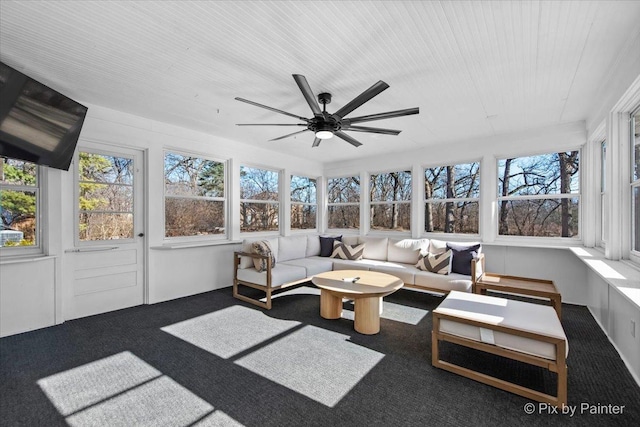 sunroom featuring a healthy amount of sunlight and a ceiling fan