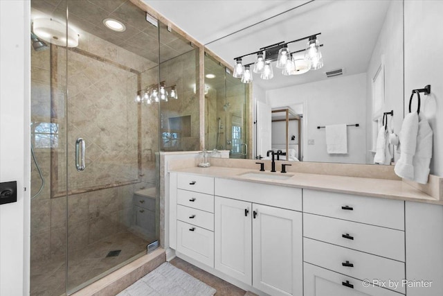 bathroom featuring a shower stall, visible vents, and vanity