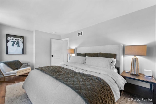 bedroom with visible vents and wood finished floors