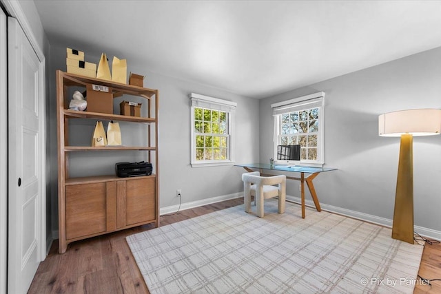 office area with baseboards and wood finished floors