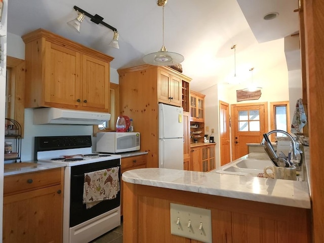 kitchen featuring glass insert cabinets, a sink, a peninsula, white appliances, and under cabinet range hood