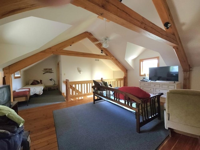 bedroom with visible vents, vaulted ceiling with beams, and wood finished floors