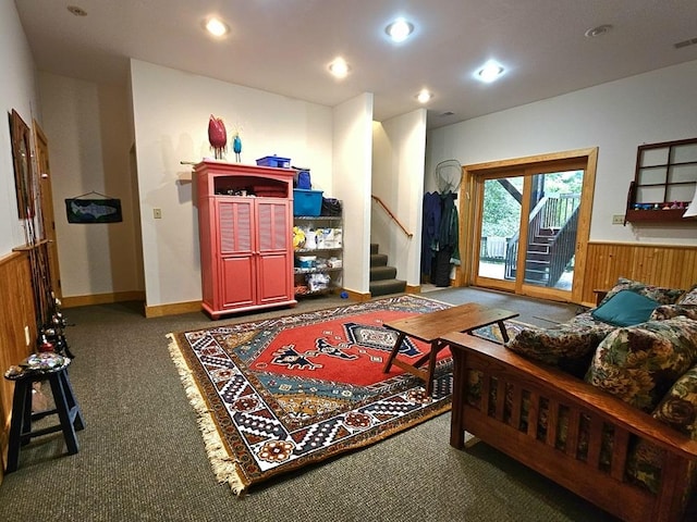 living room featuring carpet floors, a wainscoted wall, recessed lighting, stairway, and wood walls