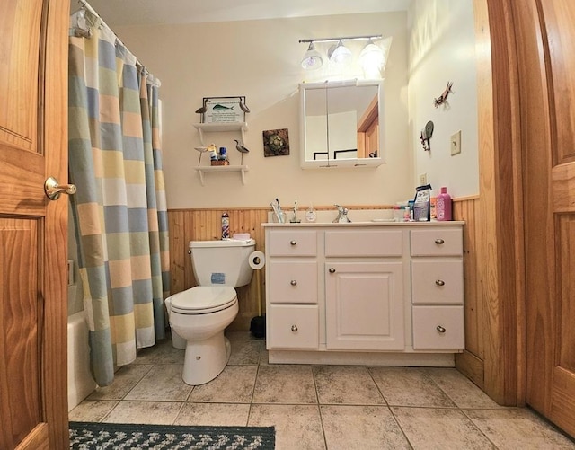 full bath featuring a wainscoted wall, wood walls, and toilet