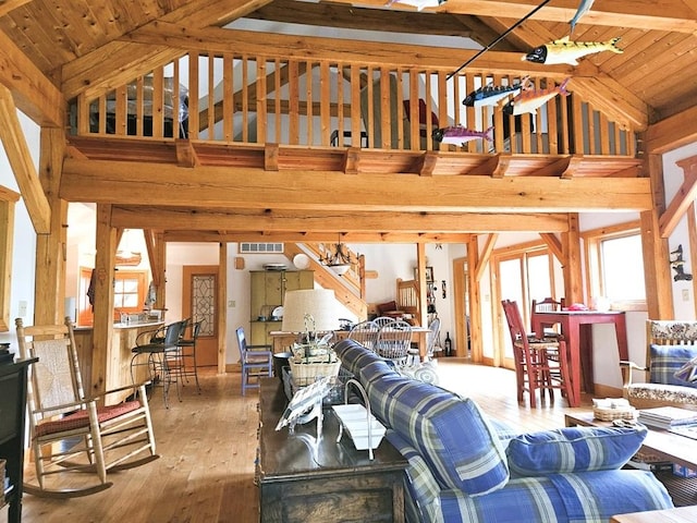 living area featuring a notable chandelier, visible vents, wood ceiling, high vaulted ceiling, and hardwood / wood-style floors