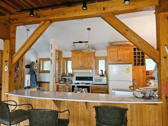 kitchen featuring vaulted ceiling with beams, a peninsula, white appliances, and ventilation hood