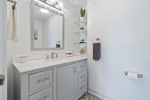 bathroom featuring baseboards and vanity