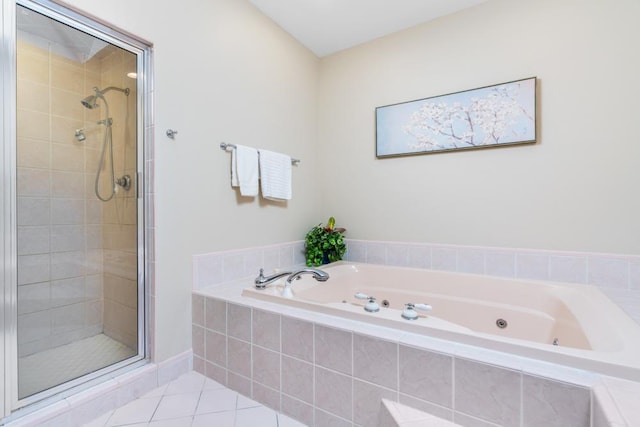 full bathroom featuring a whirlpool tub, a stall shower, and tile patterned floors