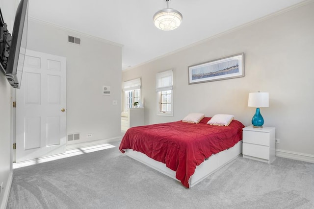 bedroom featuring ornamental molding, carpet flooring, visible vents, and baseboards