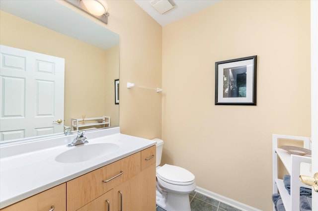 bathroom with tile patterned flooring, visible vents, baseboards, toilet, and vanity