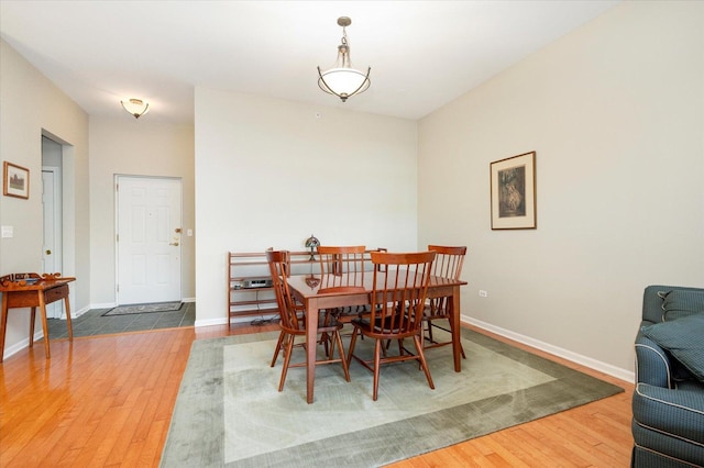 dining space featuring wood finished floors and baseboards