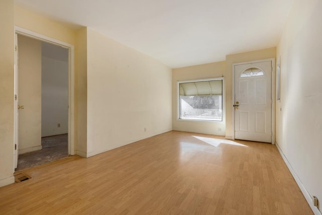 interior space with light wood-style floors and visible vents