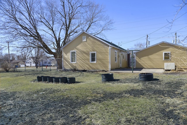 back of house featuring a patio area, a lawn, and fence