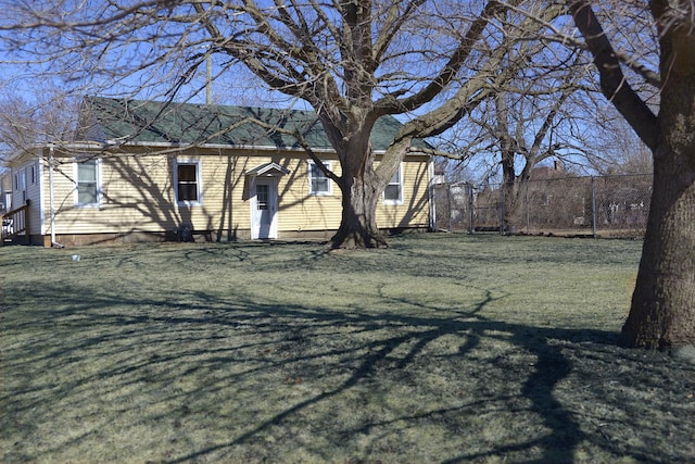 exterior space featuring fence and a lawn