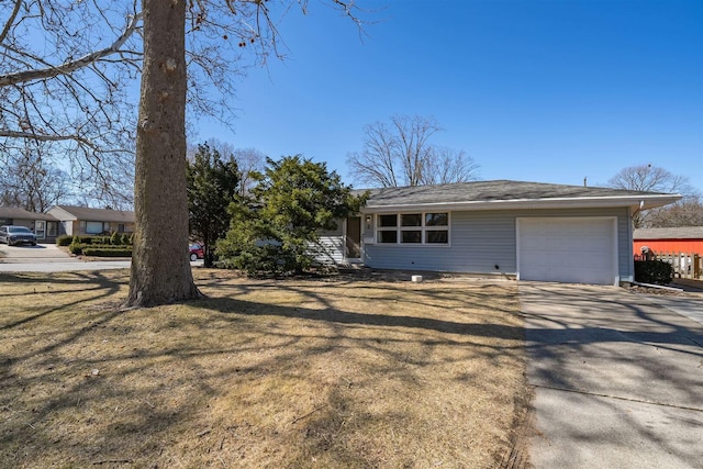 view of front of home with a front yard, an attached garage, and driveway