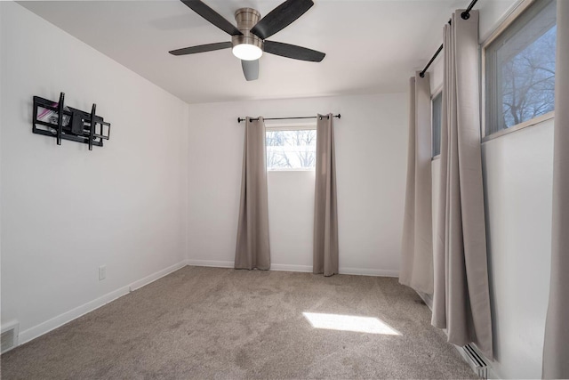 unfurnished bedroom featuring a ceiling fan, carpet flooring, baseboards, and visible vents