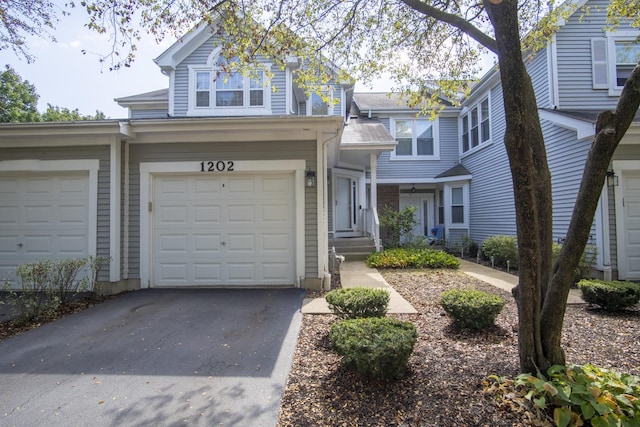 view of front facade featuring a garage and aphalt driveway