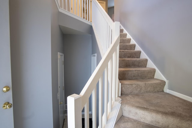 staircase with carpet and baseboards