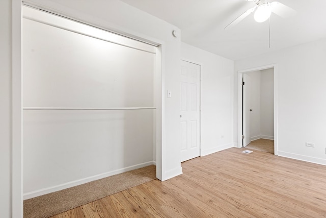 unfurnished bedroom featuring a ceiling fan, light wood-style flooring, and baseboards