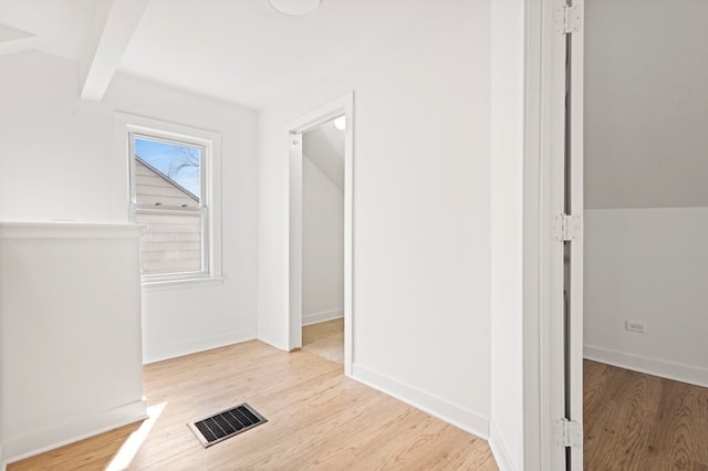 corridor featuring vaulted ceiling with beams, wood finished floors, visible vents, and baseboards