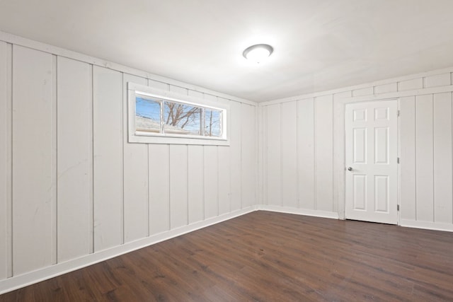 basement with baseboards and dark wood-style flooring