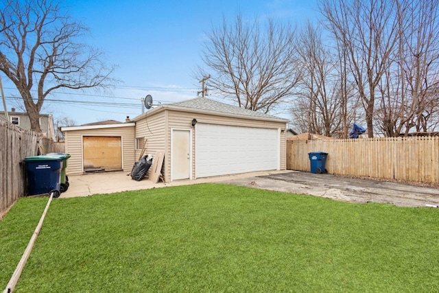 detached garage featuring fence