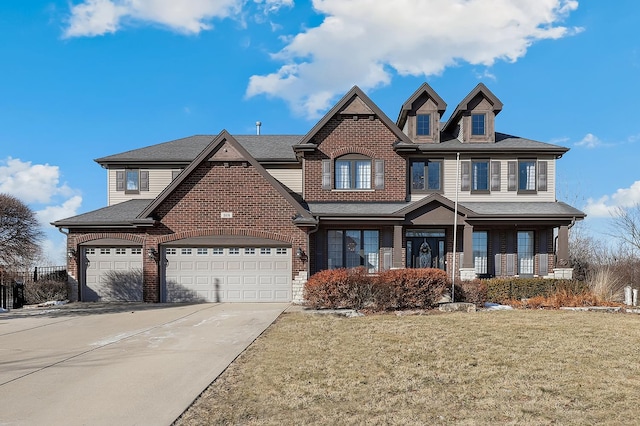 view of front of property with a front yard, brick siding, driveway, and an attached garage