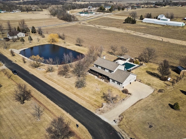 drone / aerial view with a water view and a rural view