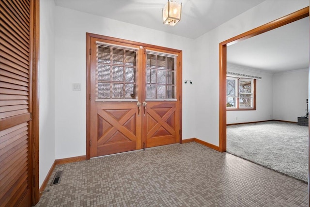 entrance foyer with visible vents, baseboards, and carpet flooring