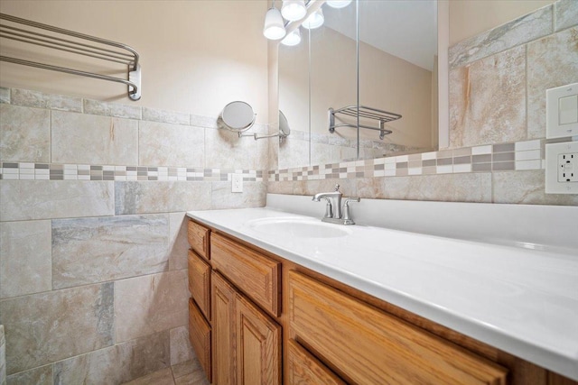 bathroom featuring tile walls and vanity