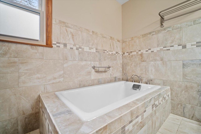 bathroom featuring a bathing tub and tile walls