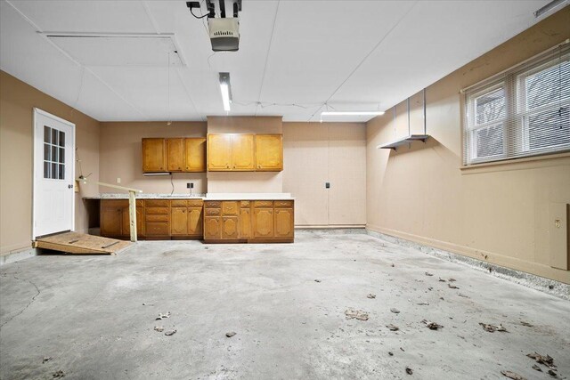 carpeted foyer entrance featuring ceiling fan, beam ceiling, and baseboards