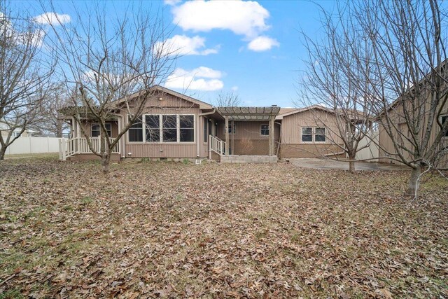 rear view of property featuring central AC unit, fence, a patio, and brick siding