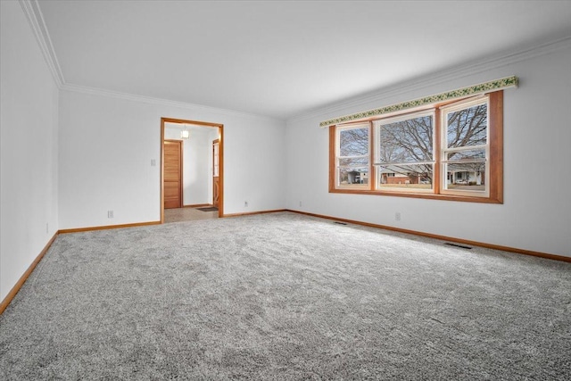 carpeted empty room with ornamental molding, visible vents, and baseboards