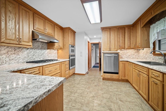 kitchen featuring under cabinet range hood, decorative backsplash, stainless steel appliances, and a sink