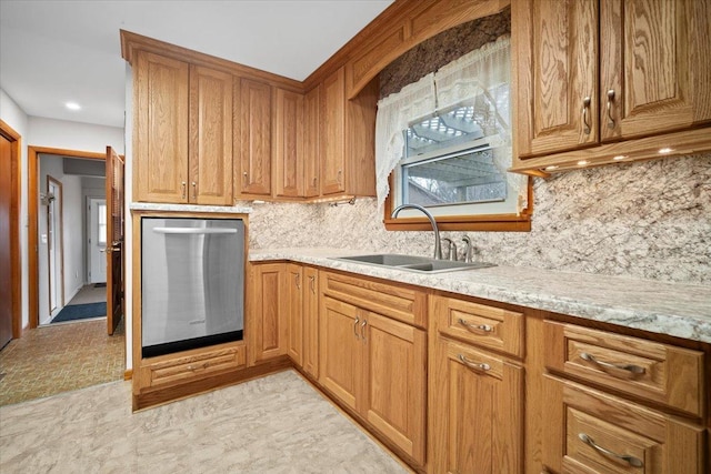 kitchen with a sink, brown cabinets, decorative backsplash, and dishwasher