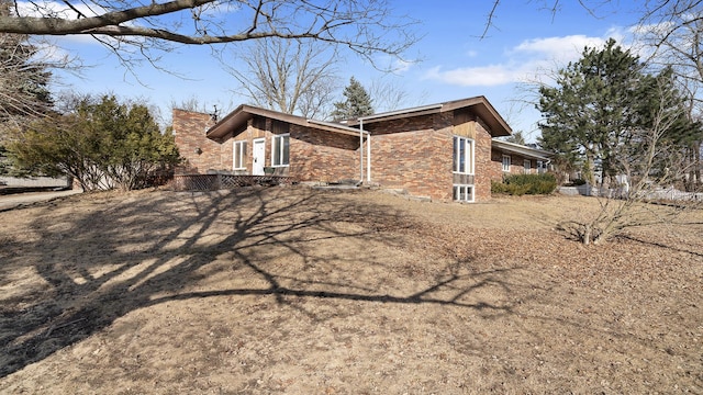 view of property exterior with brick siding