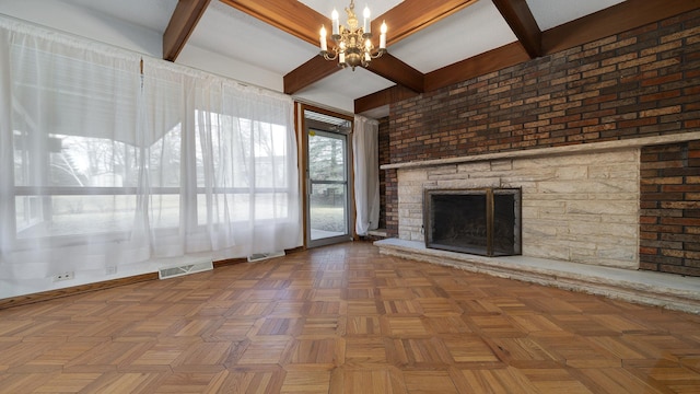 unfurnished living room with a chandelier, a stone fireplace, beamed ceiling, and visible vents