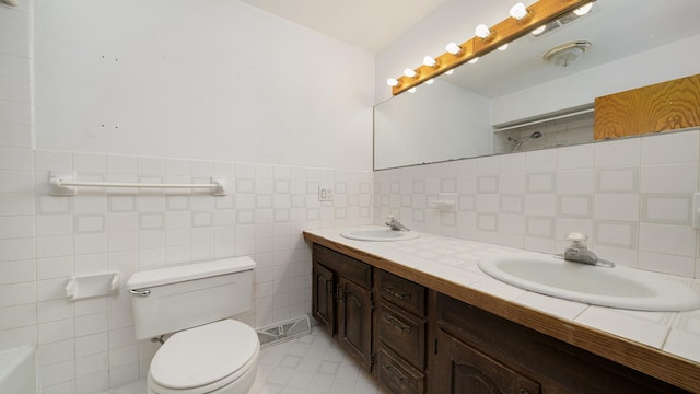 full bathroom featuring a shower, double vanity, a sink, and toilet