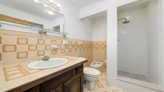 full bathroom featuring toilet, tile walls, tiled shower, tile patterned floors, and a bidet