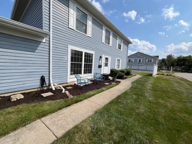 back of house featuring a yard