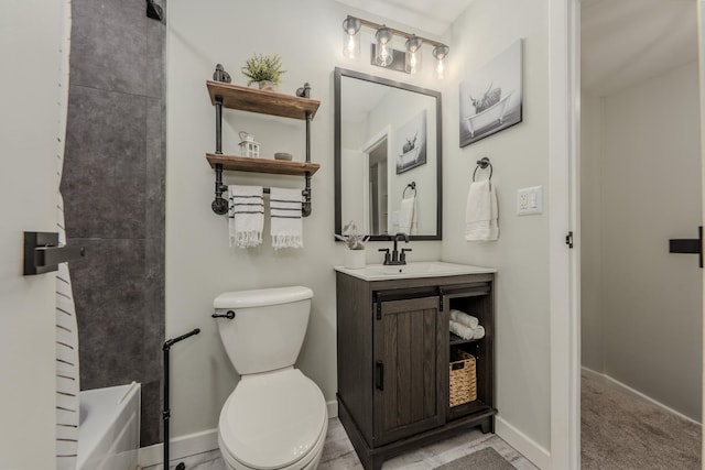 bathroom featuring toilet, a bathing tub, baseboards, and vanity